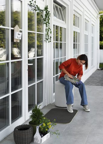 Woman Working outside of her newly Window Tinted House by Pensacola Window Tinting